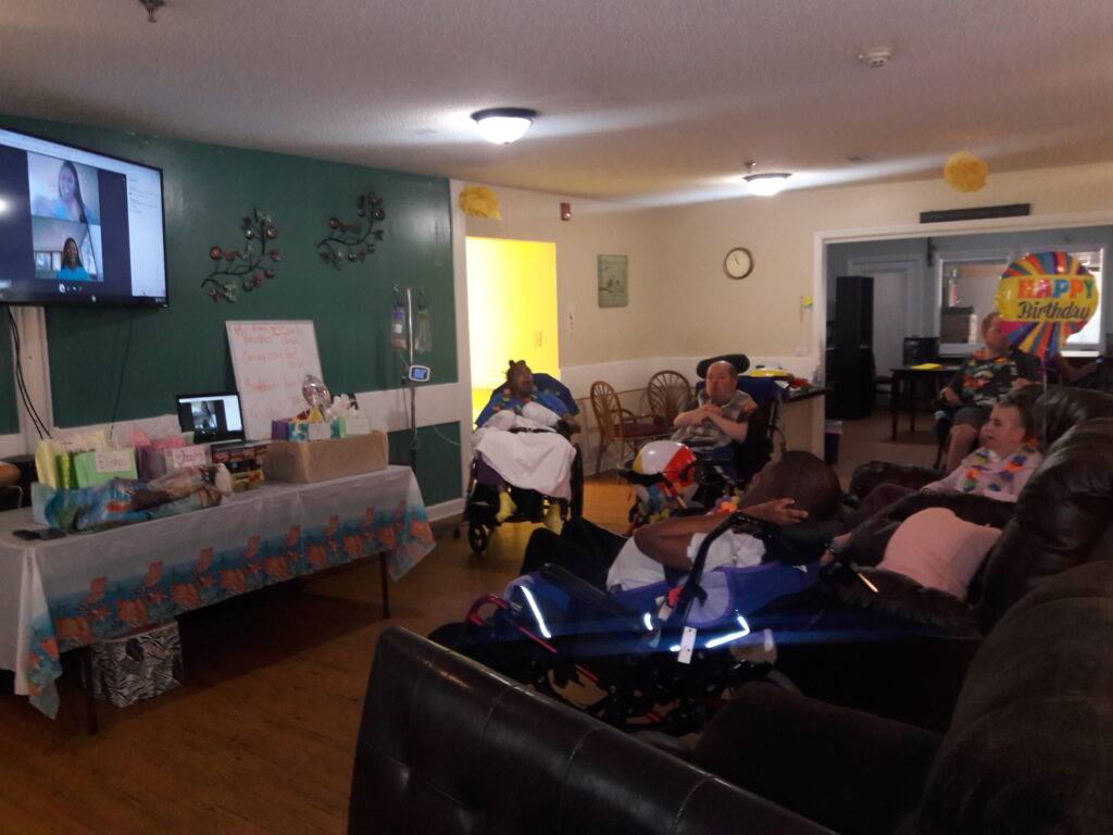 Virtual party scene with residents viewing large screen TV