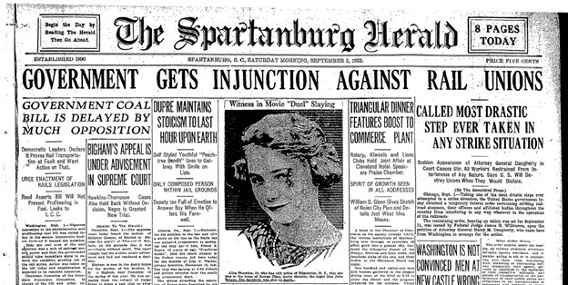 Low Quality Scan of the headlines of a 1922 issue of the Spartanburg Herald Journal with deep black lines and gray smudges along the page and on images.