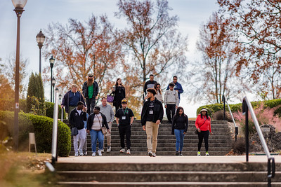 The image shows 12 USC Upstate students walking down outdoor stairs in campus.